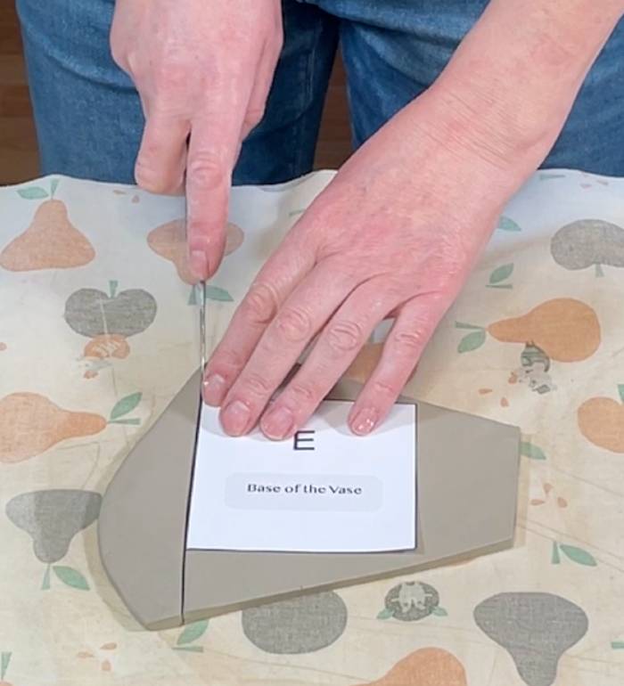 Cutting out the base of the petal-shaped vase