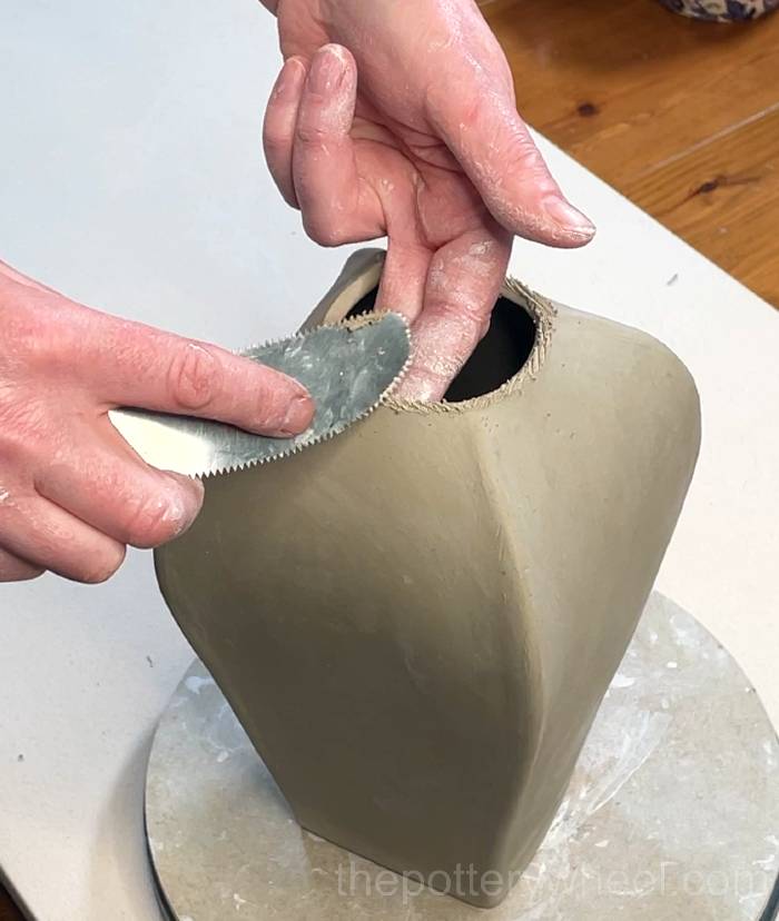 Scoring into the top edge of the vase