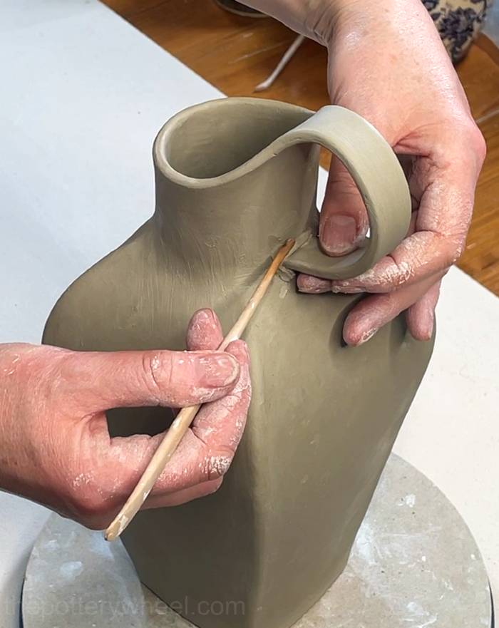 Securing the handle on the petal-shaped vase