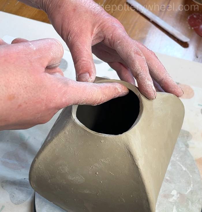 Shaping the rim of the petal-shaped vase