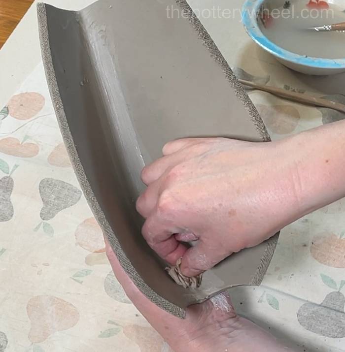Smoothing the inside of the petal-shaped vase