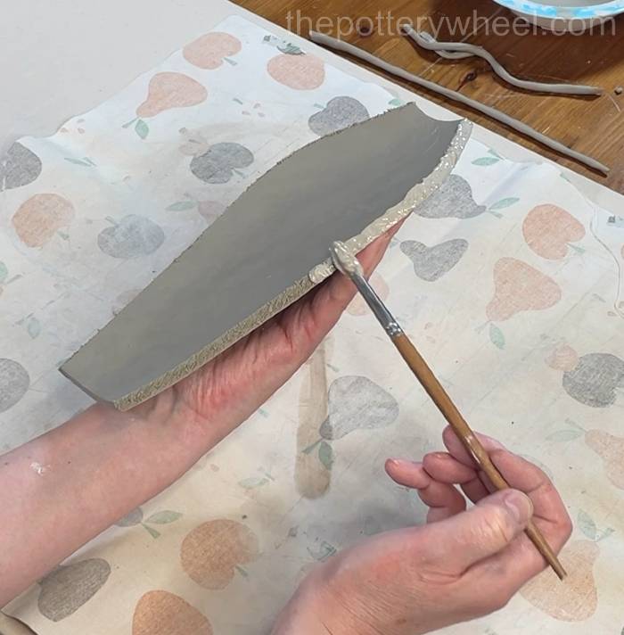 applying slip to third side of the petal shaped vase