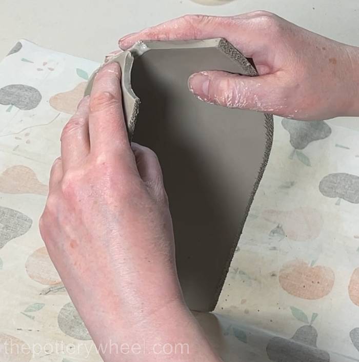 joining the top edge of the two slabs