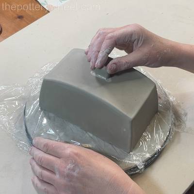 Pressing the knob of the butter dish into position