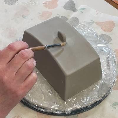 Wiping away the clay slip
