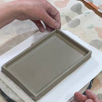 adding the small clay coil to the corner