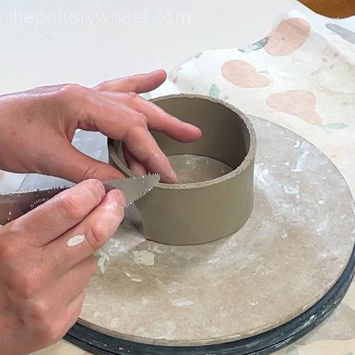 Scoring around the bottom edge of the lemon squeezer