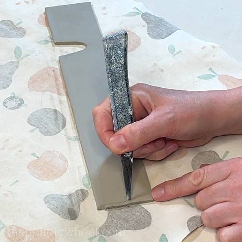 bevelling the edges of the clay slab