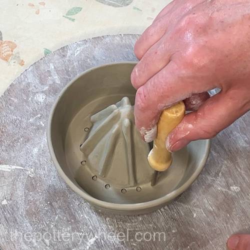 making the holes in the lemon squeezer