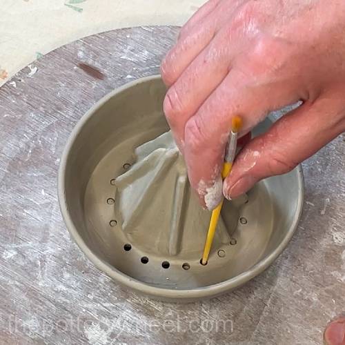 poking out the clay plugs from the lemon squeezer