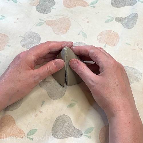 pressing the edges of the cone together