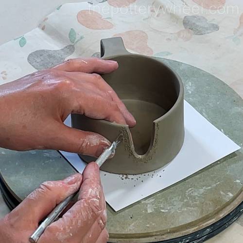 scoring the jug where the spout will be attached