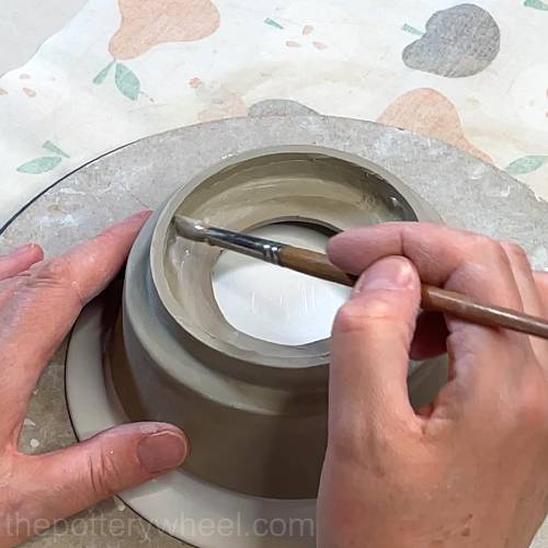 smoothing the rim with a brush