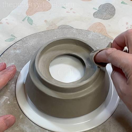 smoothing the rim with a chamois leather