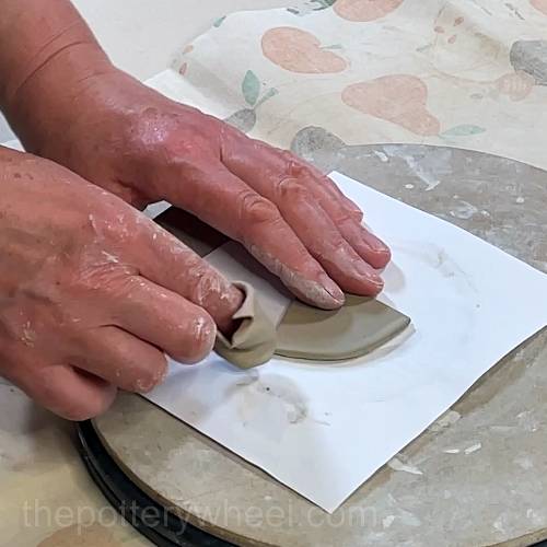 smoothing the top edge of the spout